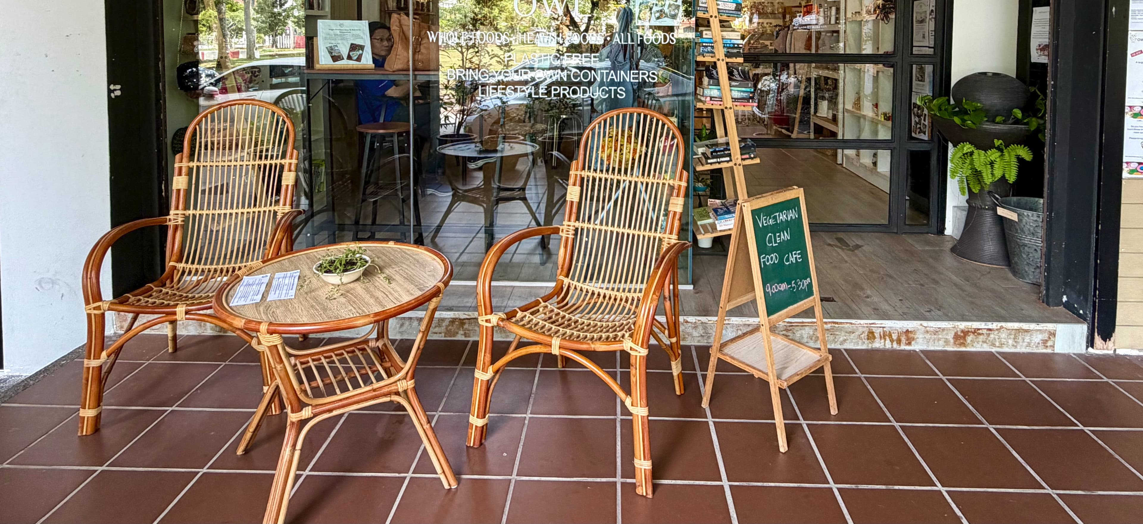 OWL Clean Food Café interior — warm wooden tables and plants